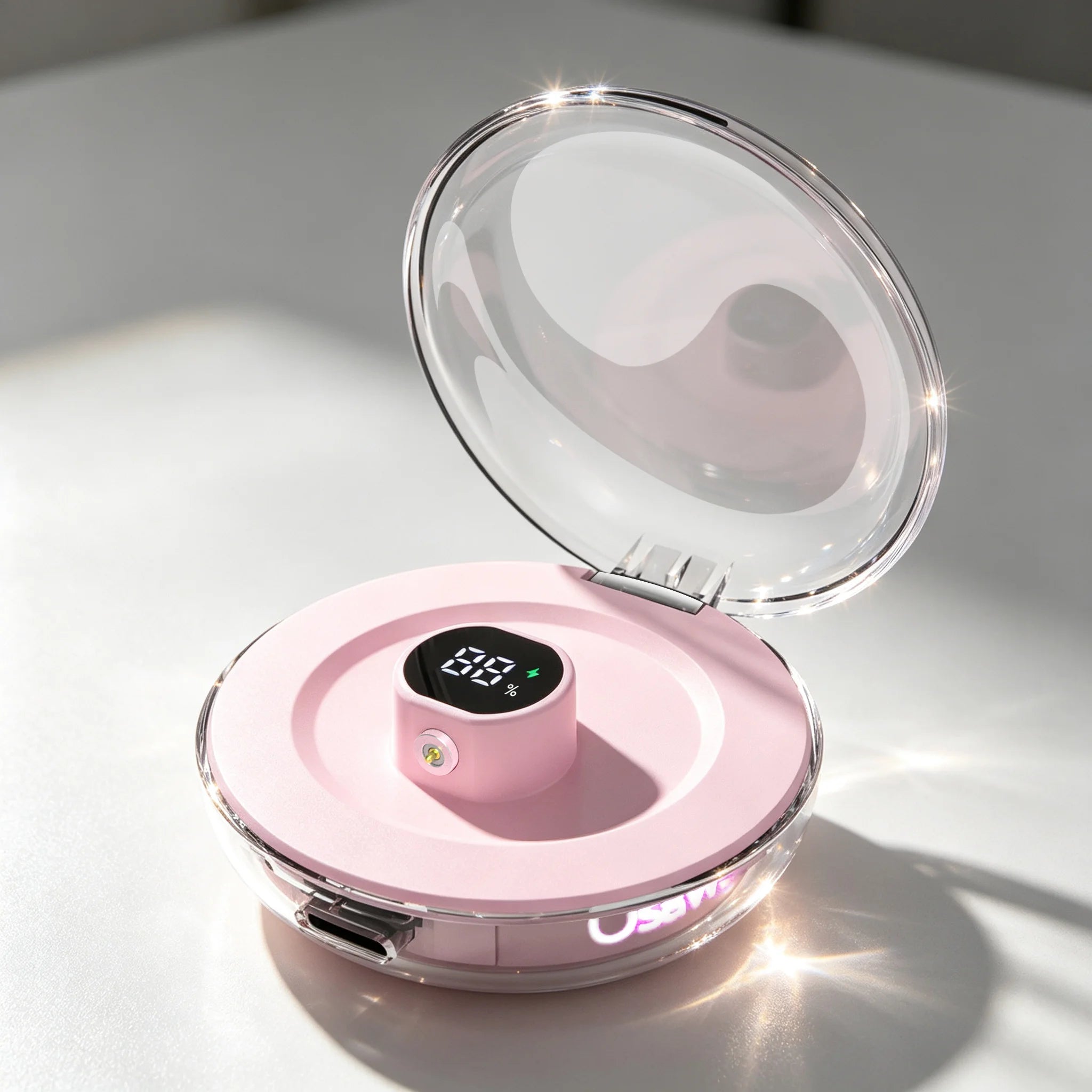 Osawalla pink smart ring charging case with transparent lid and digital battery display on clean tabletop